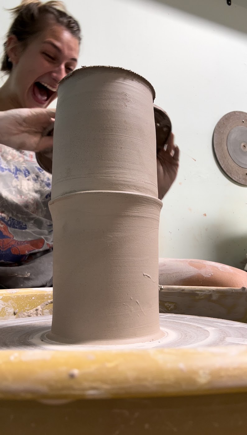 Jules laughing while working on a tall vessel at the wheel