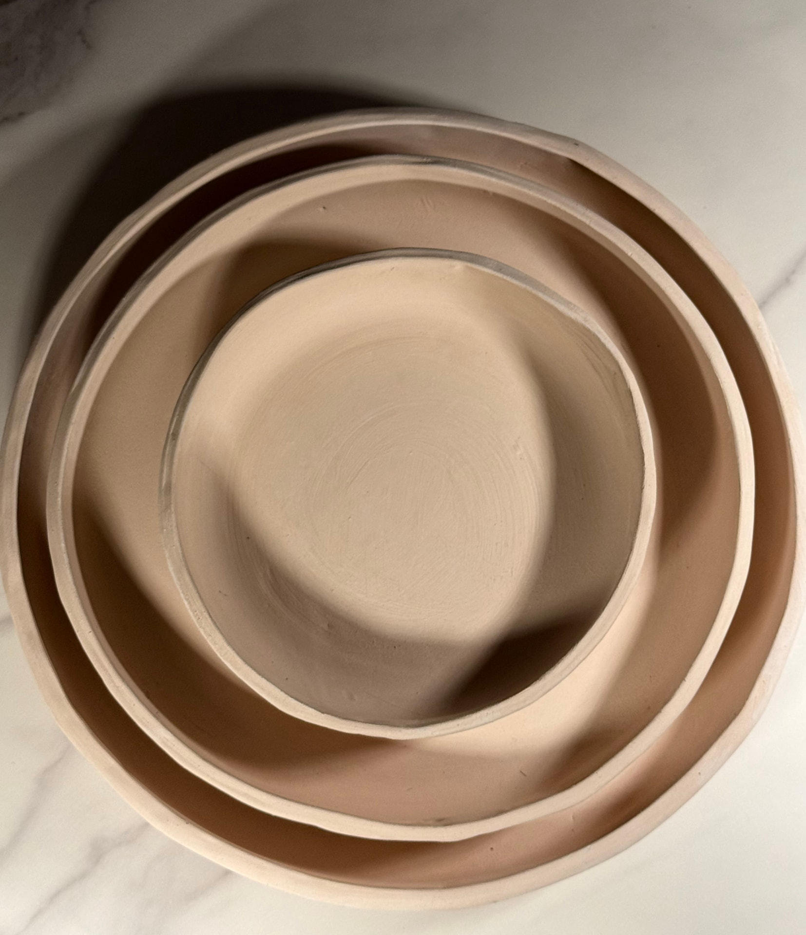 Three nesting Blates in raw bisque clay before glazing