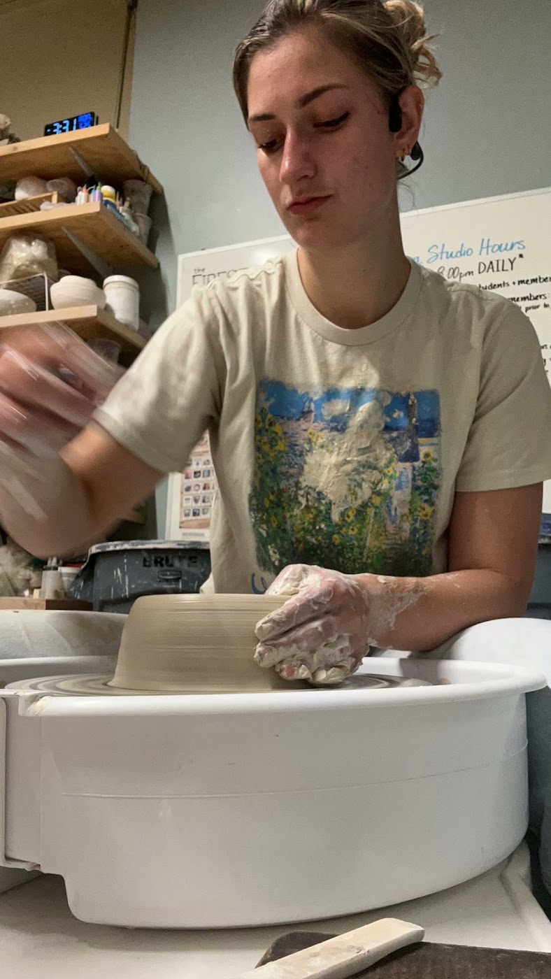 Jules shaping a bowl on the potter's wheel